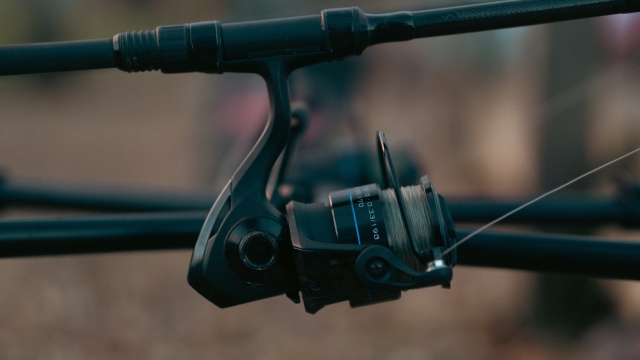 Close-up of a spinning reel mounted on a fishing rod